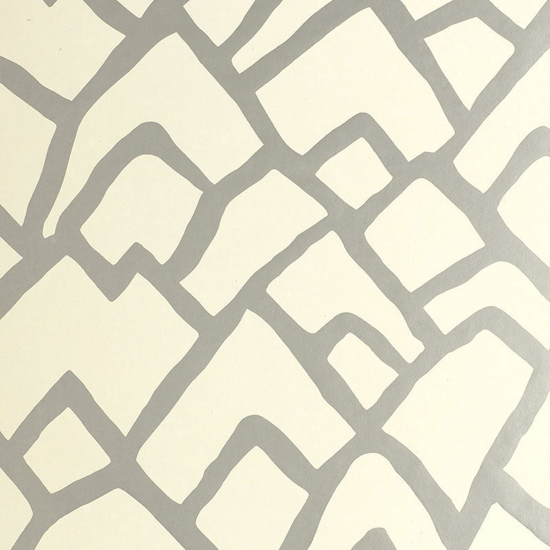 Zimba Silver geometric abstract wallpaper by Schumacher shown in a modern living room interior.