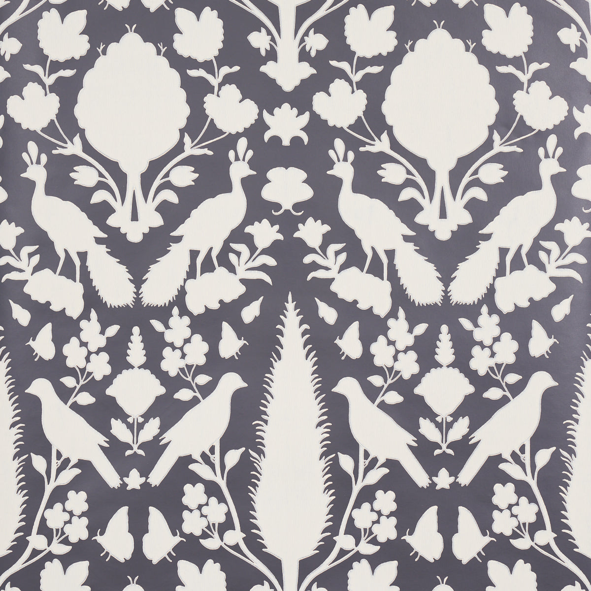 Chenonceau Charcoal wallpaper by Schumacher featuring white flora and fauna silhouettes on a charcoal background.