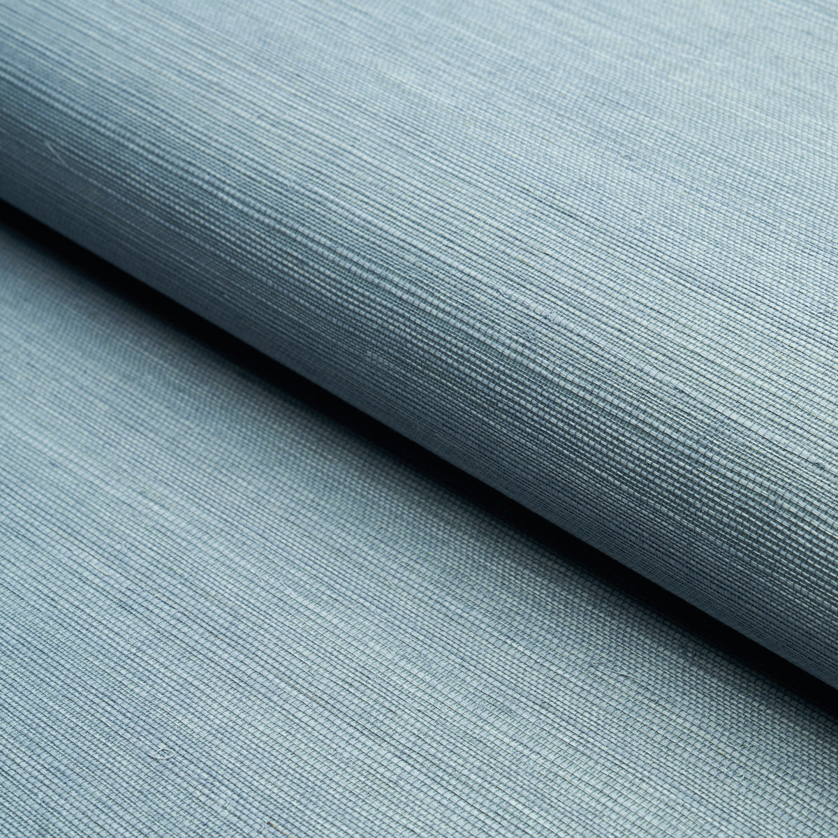 HARUKI SISAL Cornflower blue textured sisal wallcovering by Schumacher, shown in a bedroom and detail views.