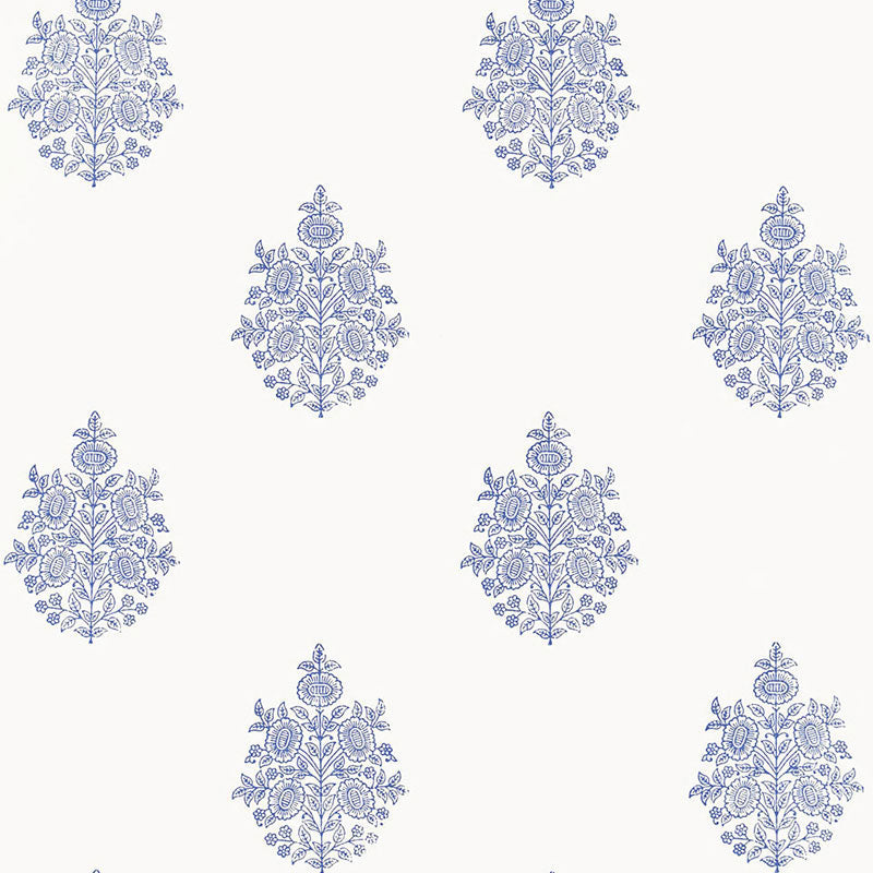 Asara Flower Delft blue and white floral medallion wallpaper by Schumacher, shown in a styled bedroom and close-up pattern view.