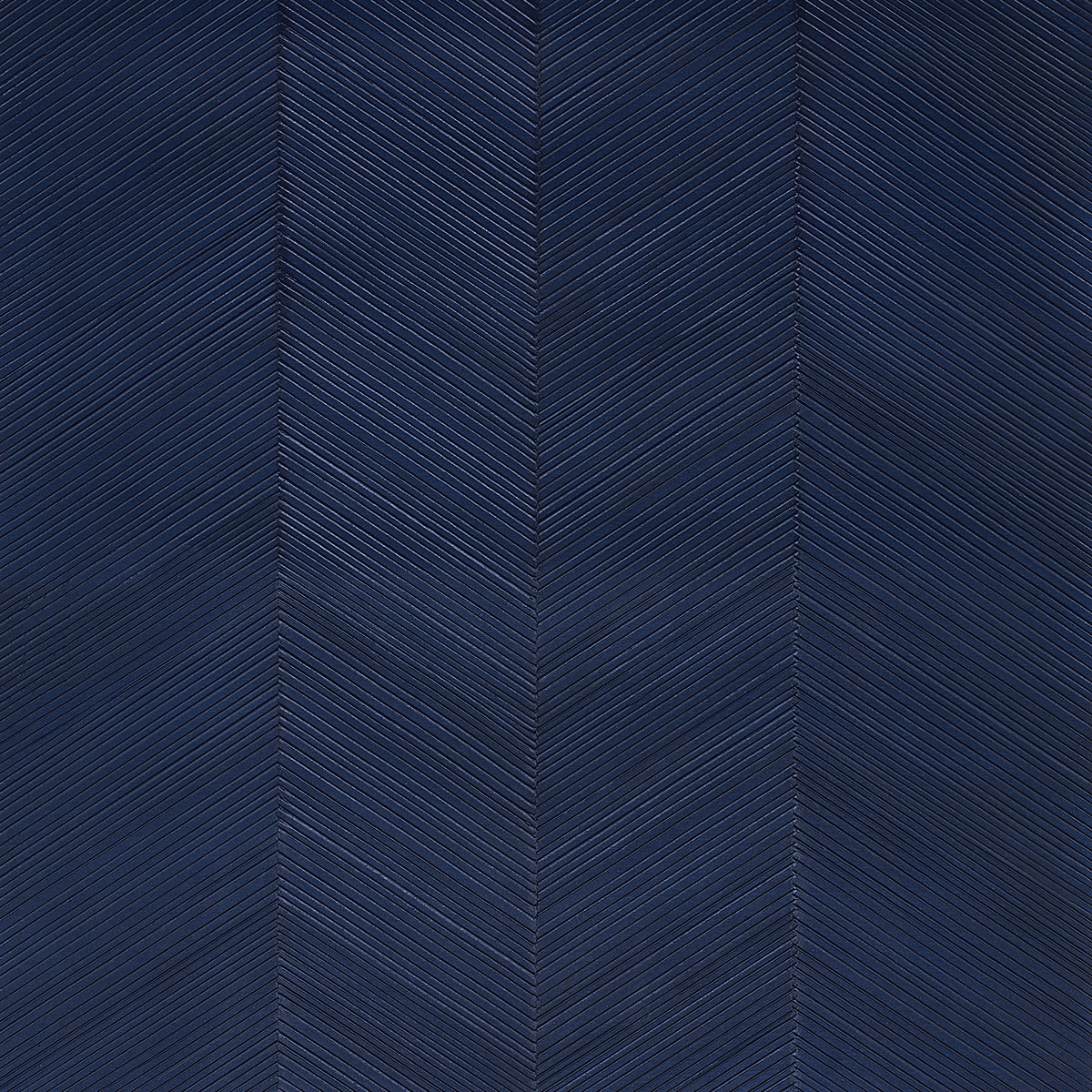 Chevron Texture wallpaper in Midnight Blue by Schumacher, featuring raised diagonal stripes forming a herringbone pattern with a metallic luster.