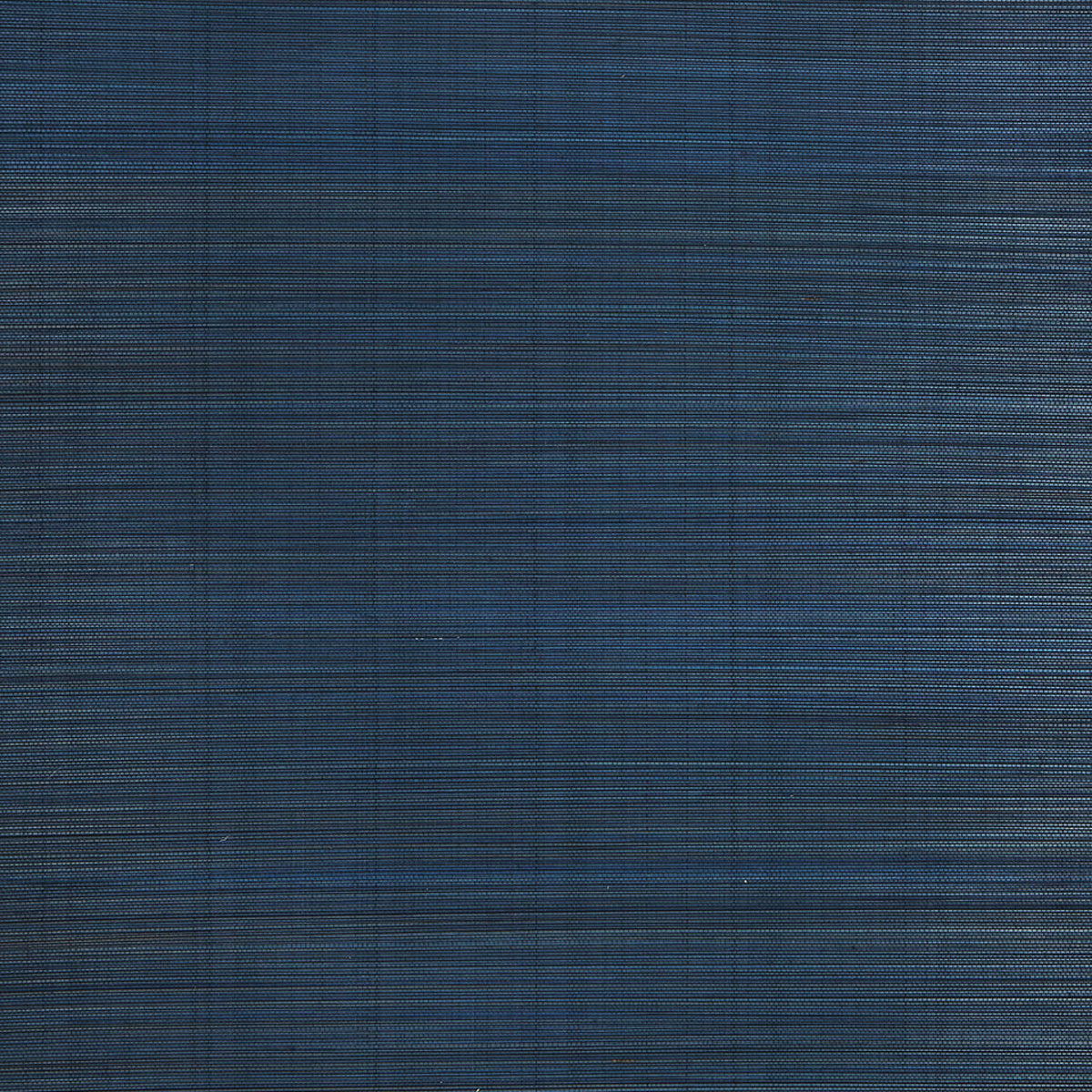 Zen Bamboo Ultramarine wallpaper by Schumacher shown as a textured blue wallcovering and installed in a modern bathroom setting.