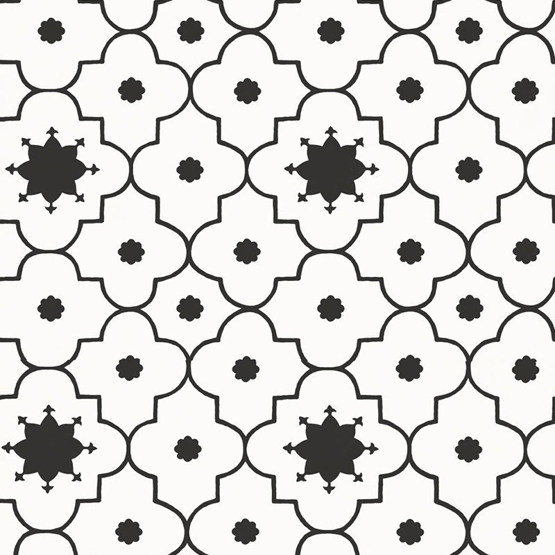 Taj Trellis Noir wallpaper by Schumacher shown in a modern interior with bold black and white geometric trellis pattern.