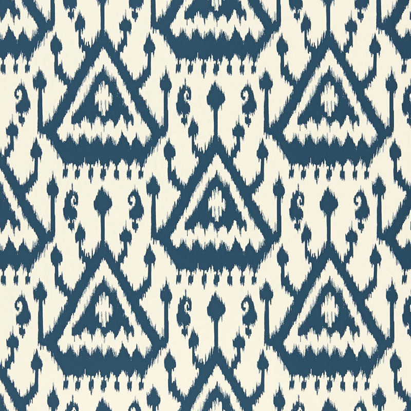 Vientiane Ikat Indigo wallpaper by Schumacher featuring a bold geometric ikat pattern in blue and white.