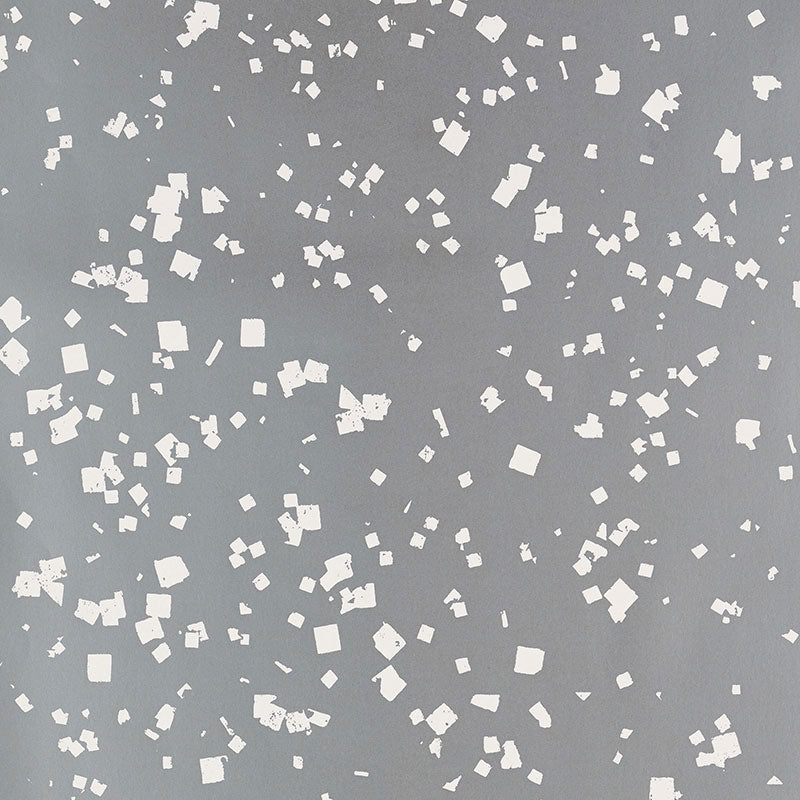 Snow wallpaper in Sterling by Schumacher, featuring a flurry of white dots and squares on a shimmering grey background.
