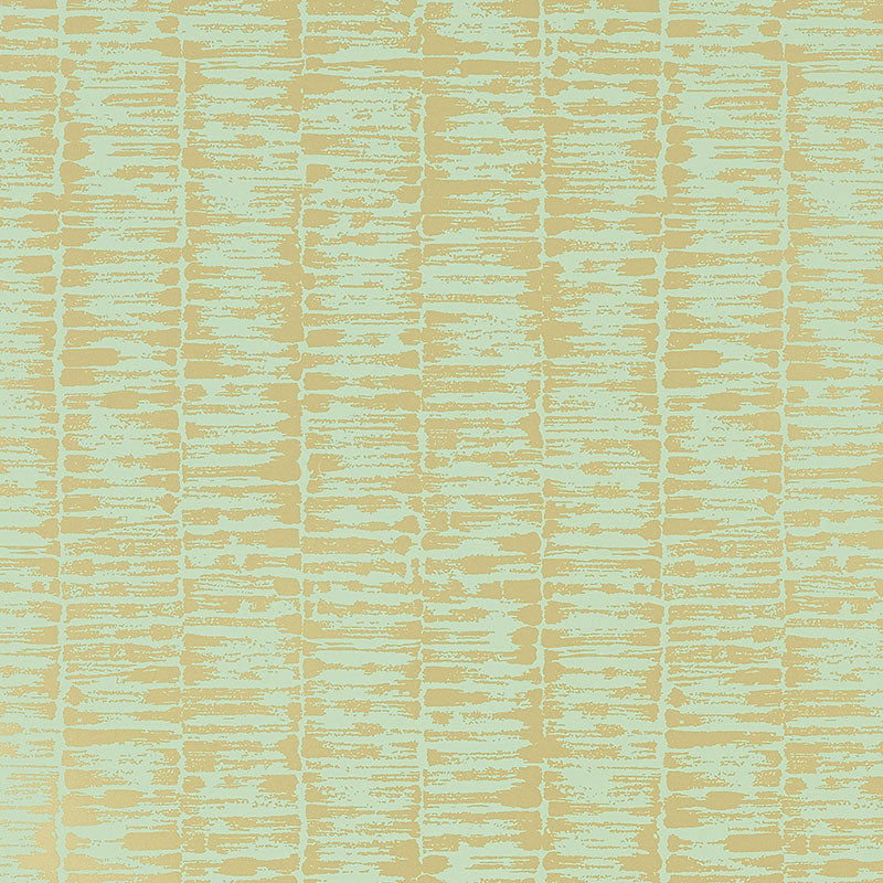 VARIATIONS Golden Leaf wallpaper by Schumacher features variegated stripes in a brushstroke pattern reminiscent of bamboo stalks, in a soft golden colorway.