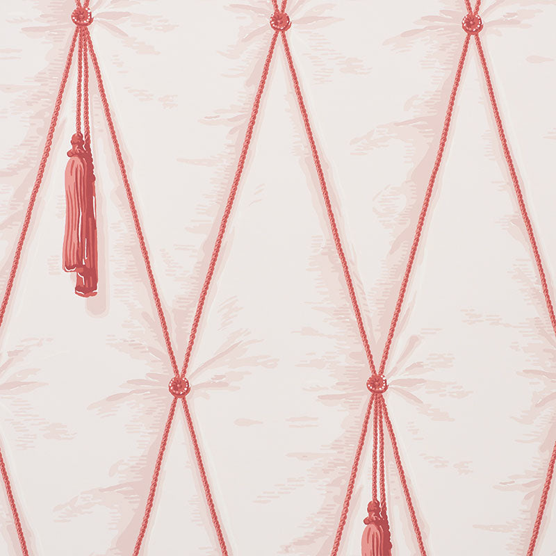 Blush pink diamond tufted trompe l'oeil wallpaper with hanging tassels by Schumacher, styled in a bedroom setting.