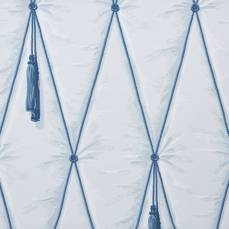 Blue diamond tufted trompe l'oeil wallpaper with hanging tassels by Schumacher, styled in a bedroom setting.