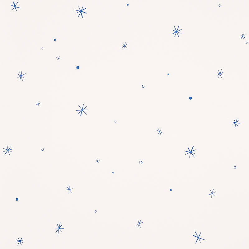 Calisto wallpaper in Ivory & Cobalt by Schumacher, featuring a playful scattered star motif in blue on an ivory background.