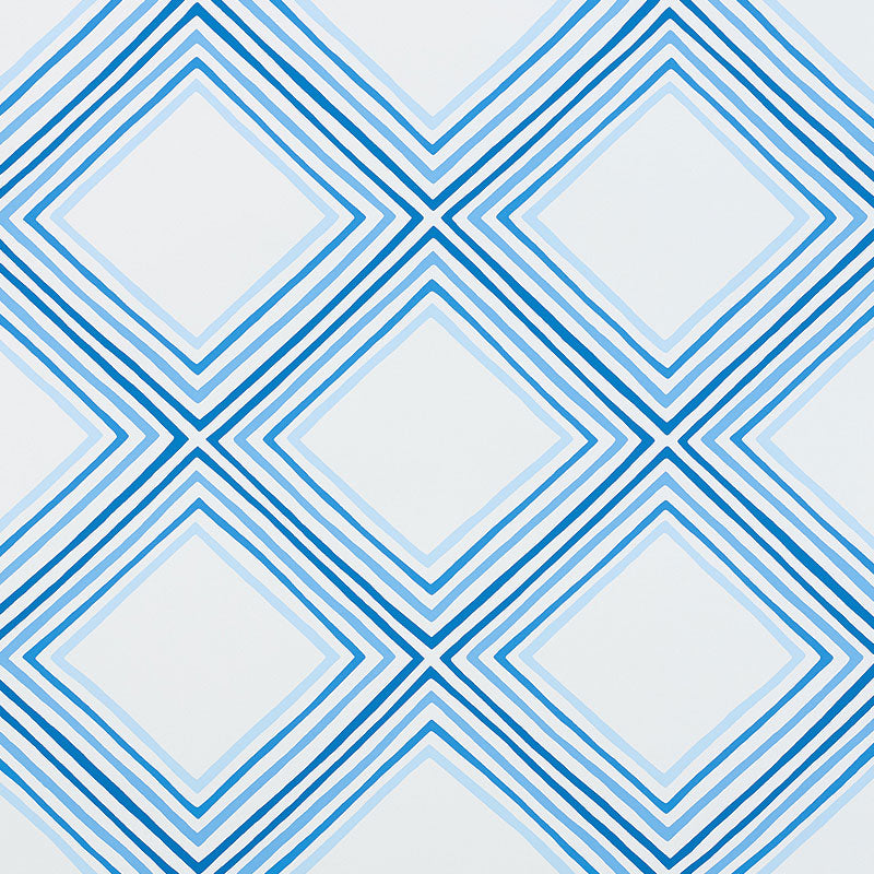 Square Dance by Vera Neumann for Schumacher. Blue geometric concentric diamond wallpaper pattern, shown in a modern interior setting.