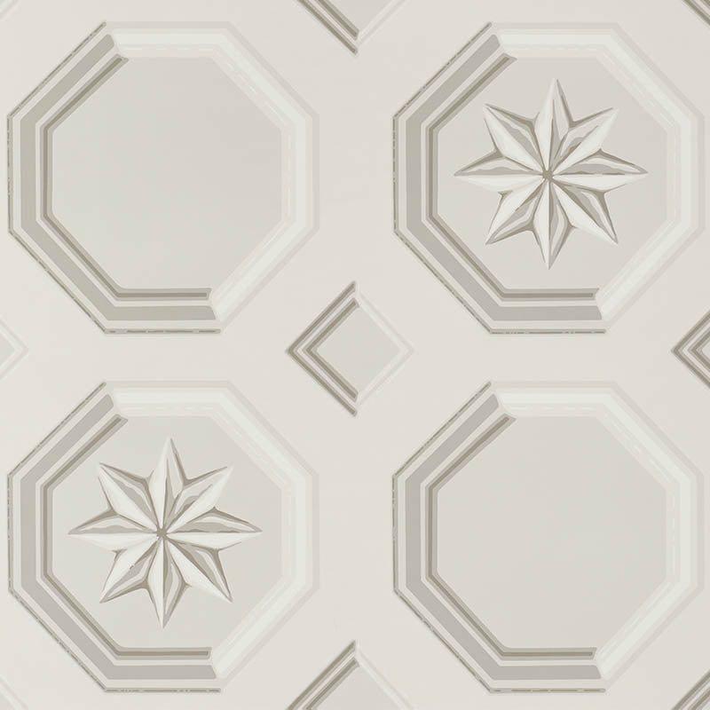 Augustus Stone wallpaper by Schumacher featuring an octagonal grid with faceted stars and floral medallions in a trompe l'oeil style.