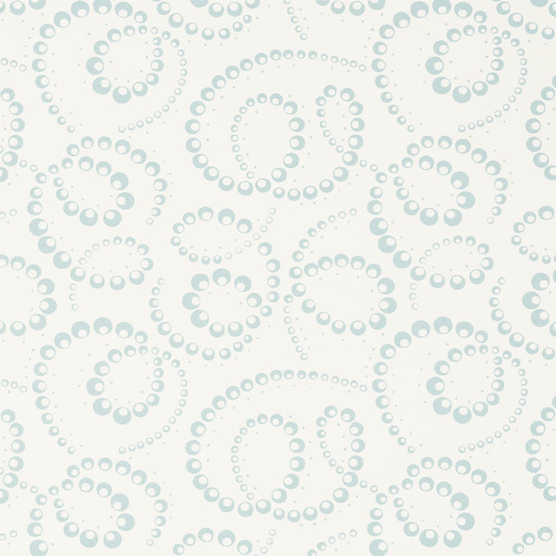 DORIAN wallpaper in Sky by Schumacher features abstracted botanical swirls in a soft blue on white background, shown in a modern bedroom setting.