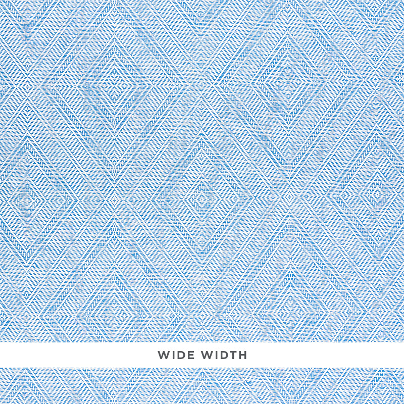 Tortola Paperweave blue diamond geometric woven wallpaper by Schumacher, shown in close-up and installed in a bathroom setting.