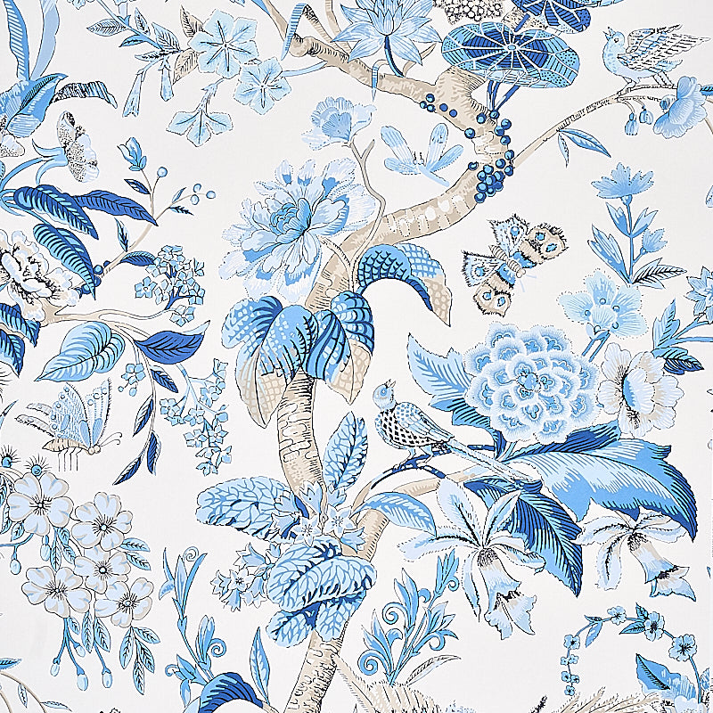 Cranley Garden wallpaper in blue by Schumacher, featuring a lively floral and bird pattern in blue and white tones.
