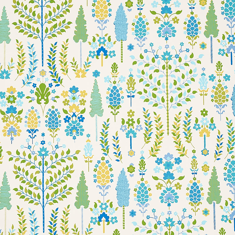 DESNA wallpaper in Peacock by Schumacher, whimsical folk-art inspired forest and floral pattern in blue, green, and yellow tones, shown in a bright bathroom setting.