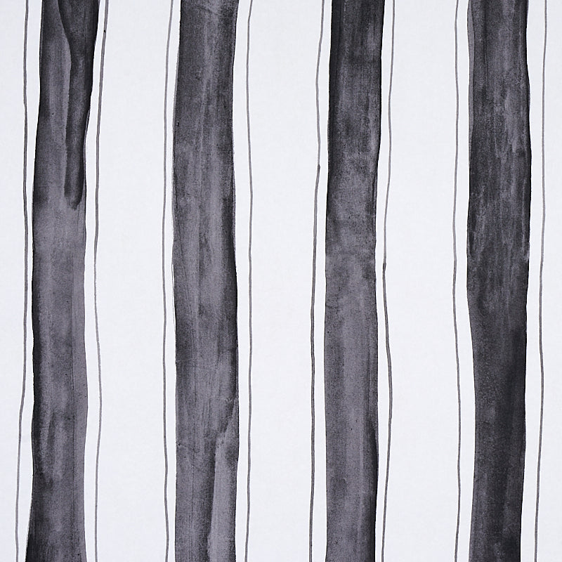 Tracing Stripes wallpaper by Schumacher, featuring bold hand-painted black vertical stripes with delicate tracing on a white background.