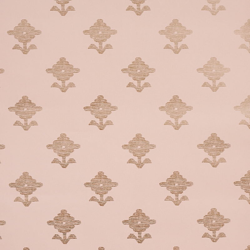 Rubia Blush wallpaper by Schumacher featuring stylized metallic floral motifs on a blush pink background, shown in a bathroom setting.