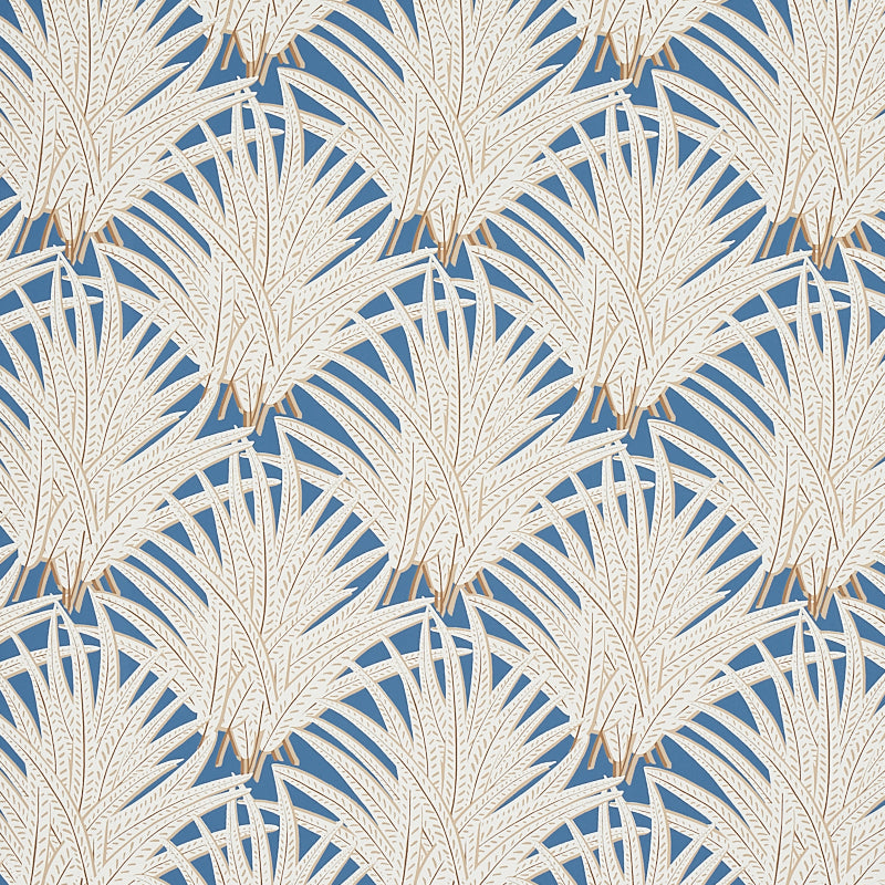 Zenada blue botanical palm leaf wallpaper from the Copacabana collection by Schumacher, shown in a styled bedroom setting.