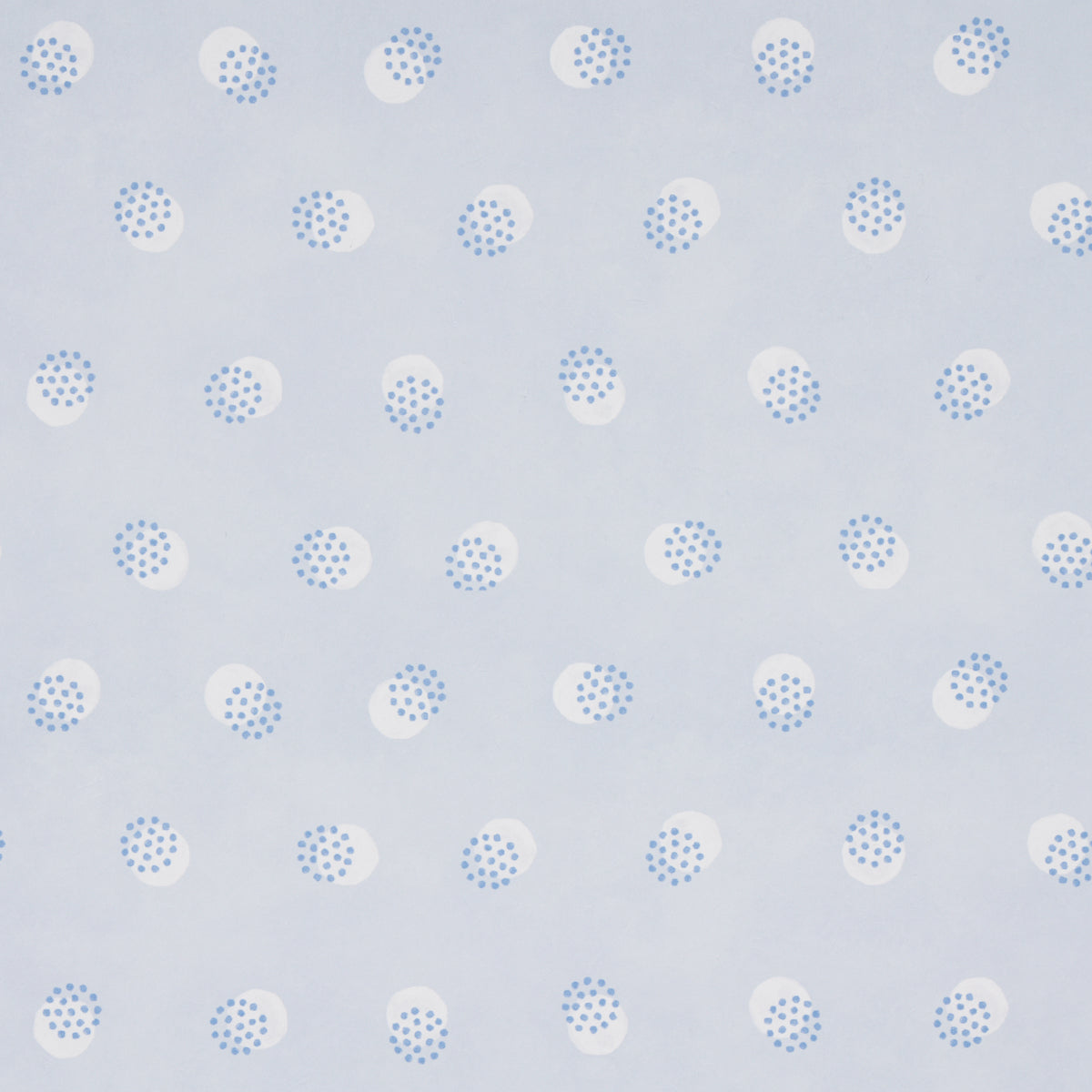Taylor Blues wallpaper by Schumacher featuring offset-printed bursts of tiny blue dots over a field of larger dots, shown in a modern interior setting.