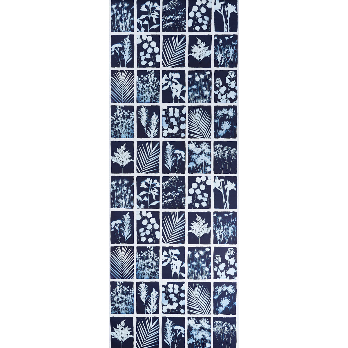 Cyanotype Panel wallpaper in indigo featuring botanical silhouettes in a grid pattern by Schumacher.
