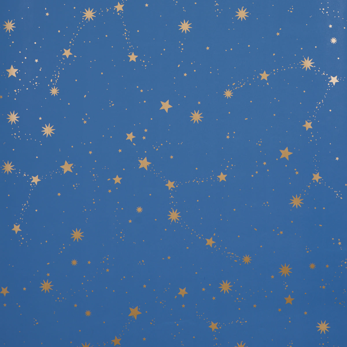 Scattered Stars wallpaper in Night by Marie-Chantal for Schumacher, featuring a constellation of metallic gold stars on a deep blue background.