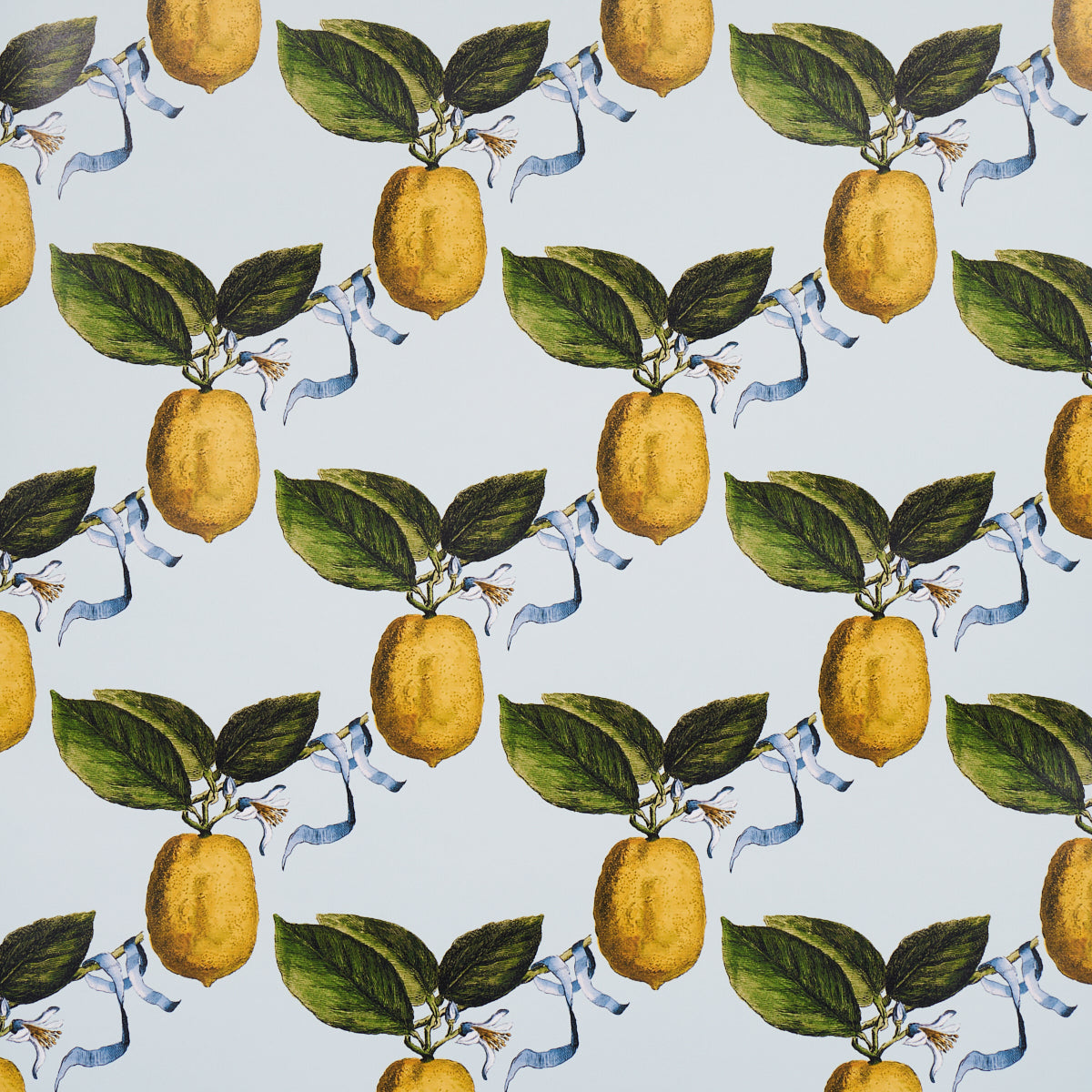 Le Citron Sky wallpaper by Johnson Hartig for Schumacher, featuring a whimsical lemon and ribbon pattern on a light blue background.