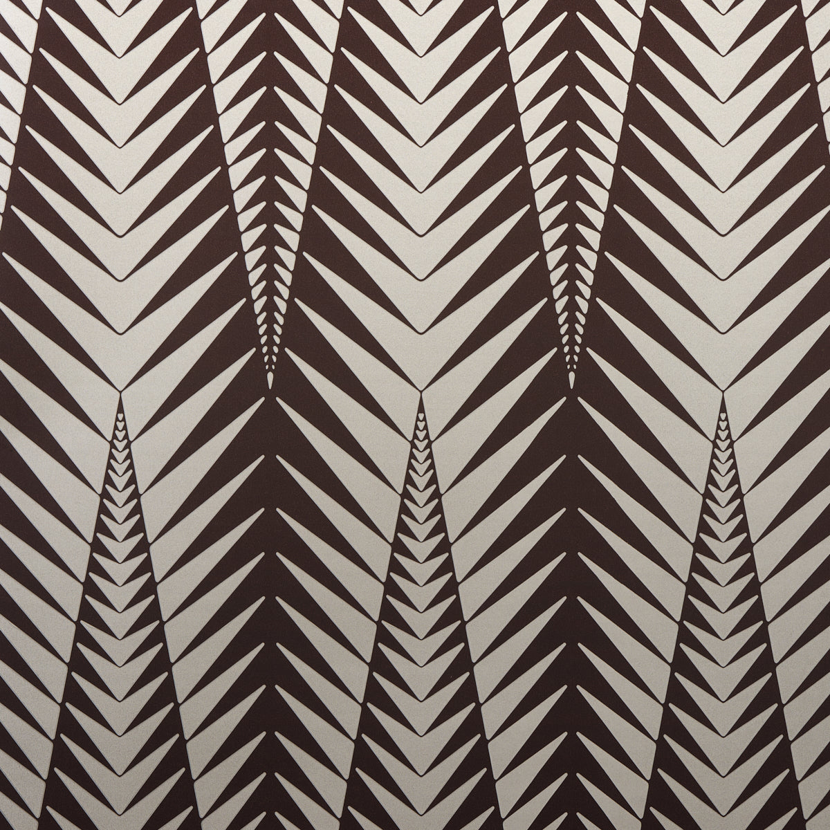 Zebra wallpaper in brown and silver by Neisha Crosland for Schumacher, featuring a bold abstract animal-inspired geometric pattern.