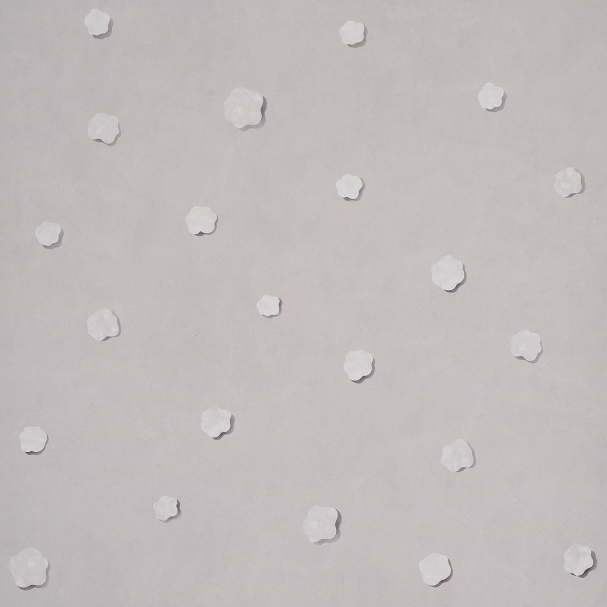 Heavenly Bodies wallpaper in gray by Schumacher, featuring abstract star and cloud motifs on a soft background.