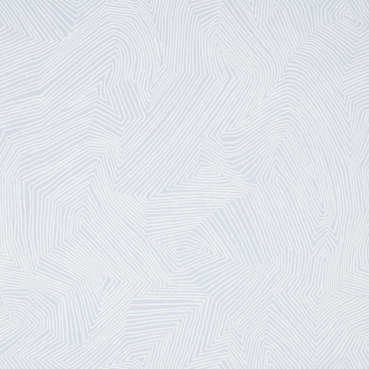 Labyrinth Grand wallpaper in Sky by Schumacher, large-scale geometric pattern in light blue and white, shown in a styled bedroom interior.