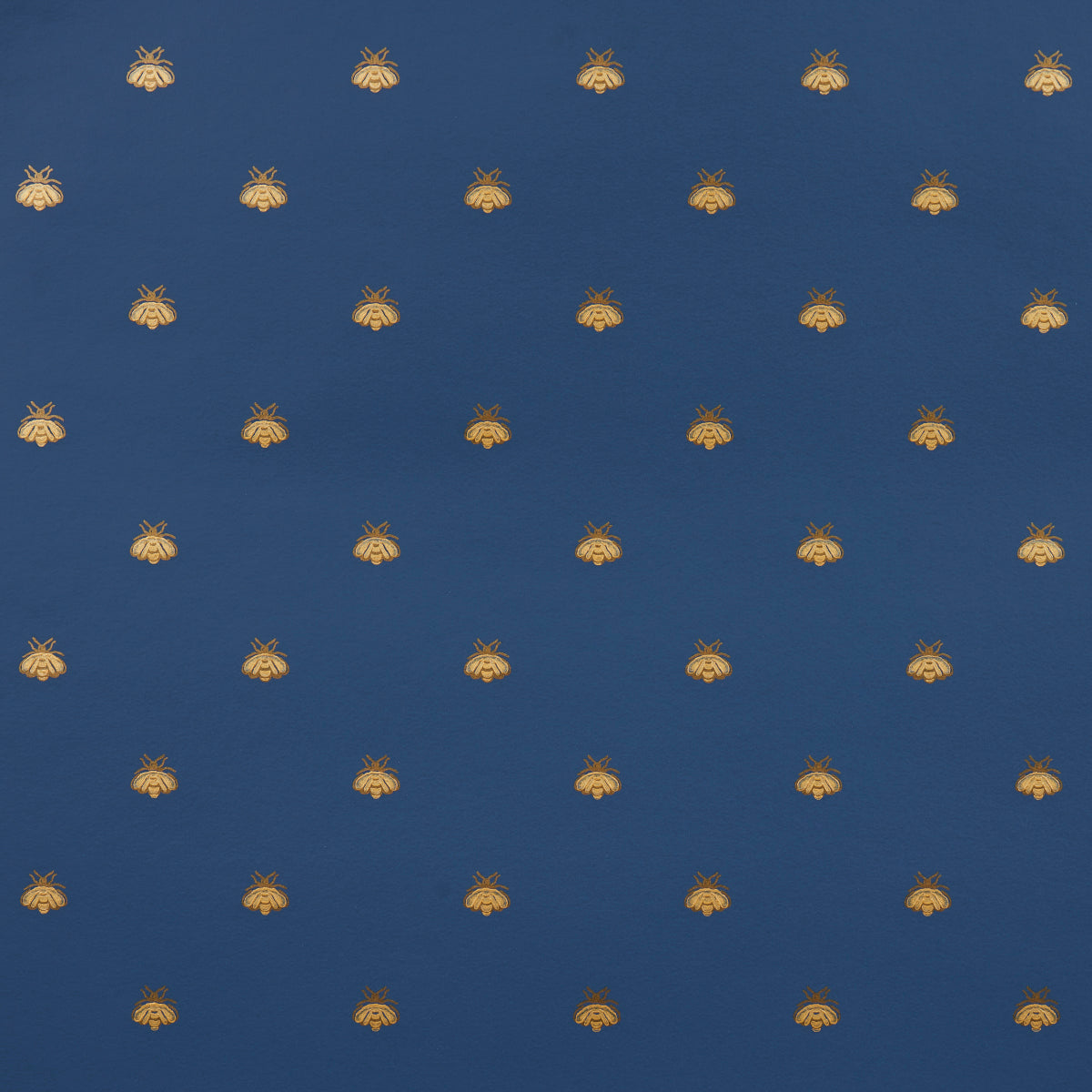 Hubert's Bees wallpaper in Midnight & Gold by Schumacher, featuring a small-scale gold bee motif on a deep blue background.
