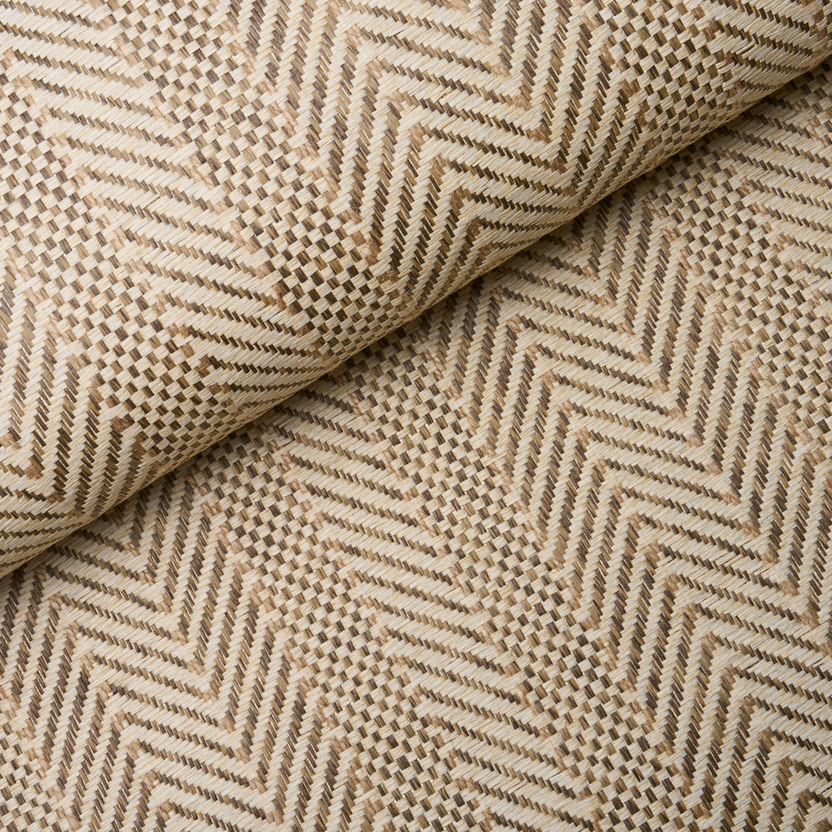 Zigzag Paperweave wallpaper in flax colorway, featuring a pronounced herringbone texture and woven pattern, styled in a modern interior setting.