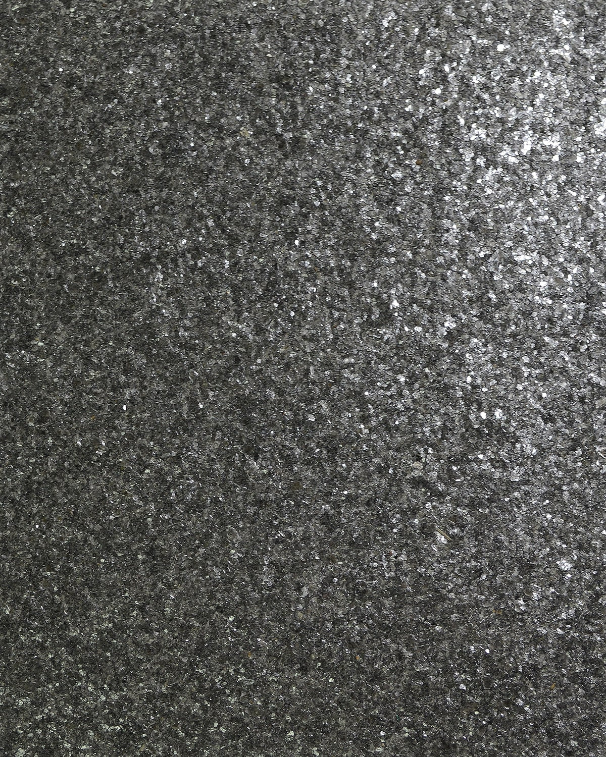 Close-up texture of Lillian August Mica grasscloth wallpaper in Onyx (black) with a satin finish.