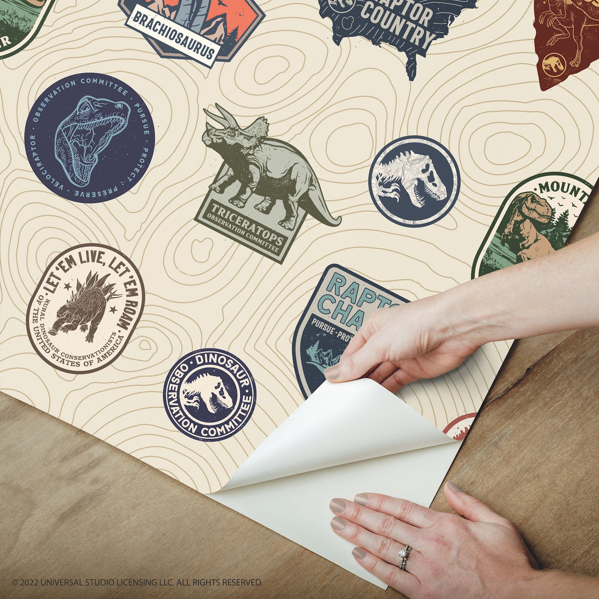 Jurassic World Badges Multicolor Peel & Stick Vinyl Wallpaper with Retro Dinosaur Patch Motif - York RMK12397RL