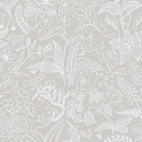 Grazia wallpaper in grey by Boråstapeter for Schumacher, featuring a whimsical garden motif with hidden faces and hands in a surrealist style.