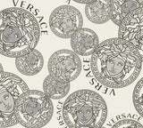 Versace Dynasty wallpaper in Snowbound with grey Medusa medallions and Versace lettering on an off-white satin vinyl ground.