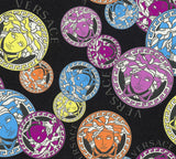 Versace Dynasty wallpaper in Galaxy colorway featuring colorful Medusa-style medallions on a black textured ground.