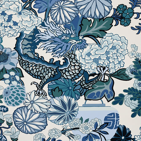 Chiang Mai Dragon China Blue wallpaper by Schumacher featuring a bold chinoiserie dragon and floral motif in blue and white tones.