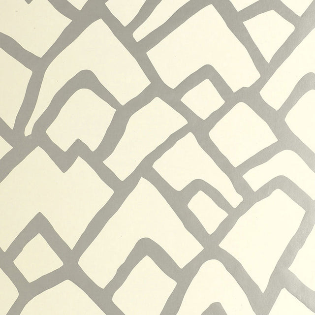Zimba Silver geometric abstract wallpaper by Schumacher shown in a modern living room interior.