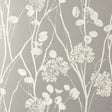 Moonpennies wallpaper in silver by Schumacher, featuring delicate botanical silhouettes on a metallic background, shown in a modern bathroom setting.