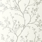 Twiggy Silver wallpaper by Schumacher featuring delicate flowering branches silhouetted against a solid ground.