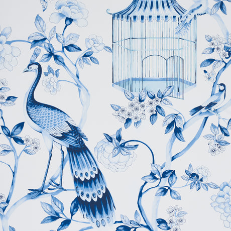 OISEAUX ET FLEURS wallpaper in Porcelain by Schumacher, featuring blue birds, birdcages, and flowers in a chinoiserie style.
