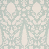 Chenonceau Aquamarine wallpaper by Schumacher featuring white flora and fauna silhouettes on a soft aquamarine background.