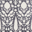 Chenonceau Charcoal wallpaper by Schumacher featuring white flora and fauna silhouettes on a charcoal background.