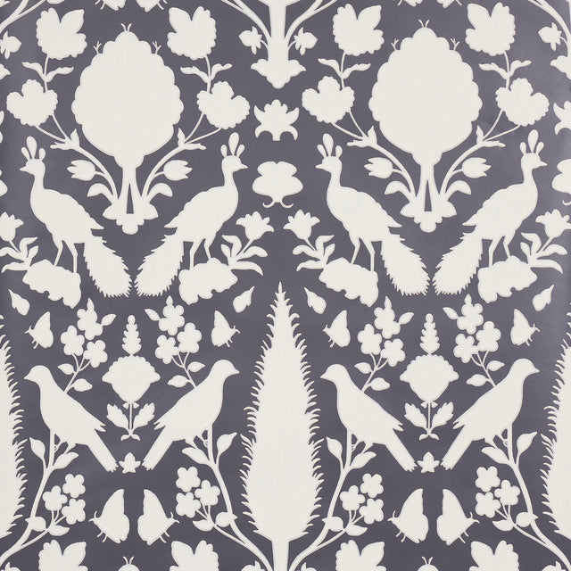 Chenonceau Charcoal wallpaper by Schumacher featuring white flora and fauna silhouettes on a charcoal background.