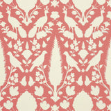 Chenonceau Coral wallpaper by Schumacher featuring a 17th-century Persian damask-inspired design with flora and fauna silhouettes in coral and white.