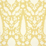 Chenonceau Buttercup wallpaper by Schumacher featuring a Persian damask-inspired pattern with birds and flora in yellow and white.