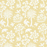 Palm Damask Sunlight wallpaper by Schumacher, featuring a whimsical damask pattern with palm trees, birds, and animals in white on a yellow background.