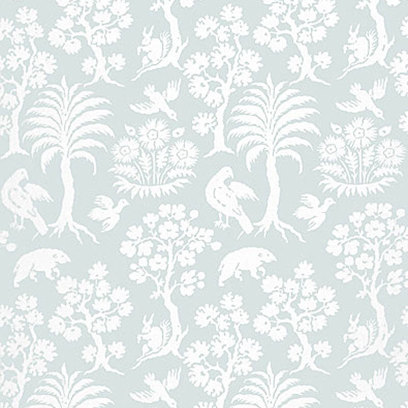 Palm Damask wallpaper in Sky by Schumacher, featuring a whimsical damask pattern with palm trees, birds, and animals in white on a pale blue background.