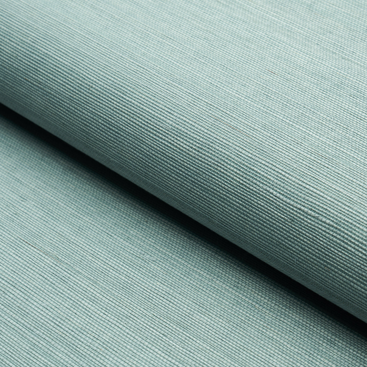 Close-up of Haruki Sisal wallpaper in Robin's Egg blue by Schumacher, showing its textured, woven surface.