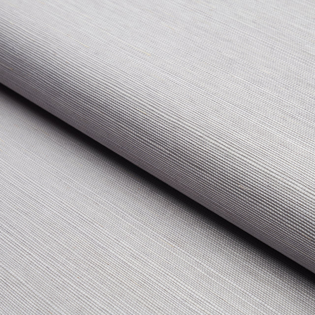 Close-up of Haruki Sisal lavender textured wallcovering by Schumacher, showing fine woven detail and subtle sheen.